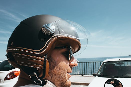 Close-up of a man with a helmet enjoying the seaside view at Beaulieu-sur-Mer, France.