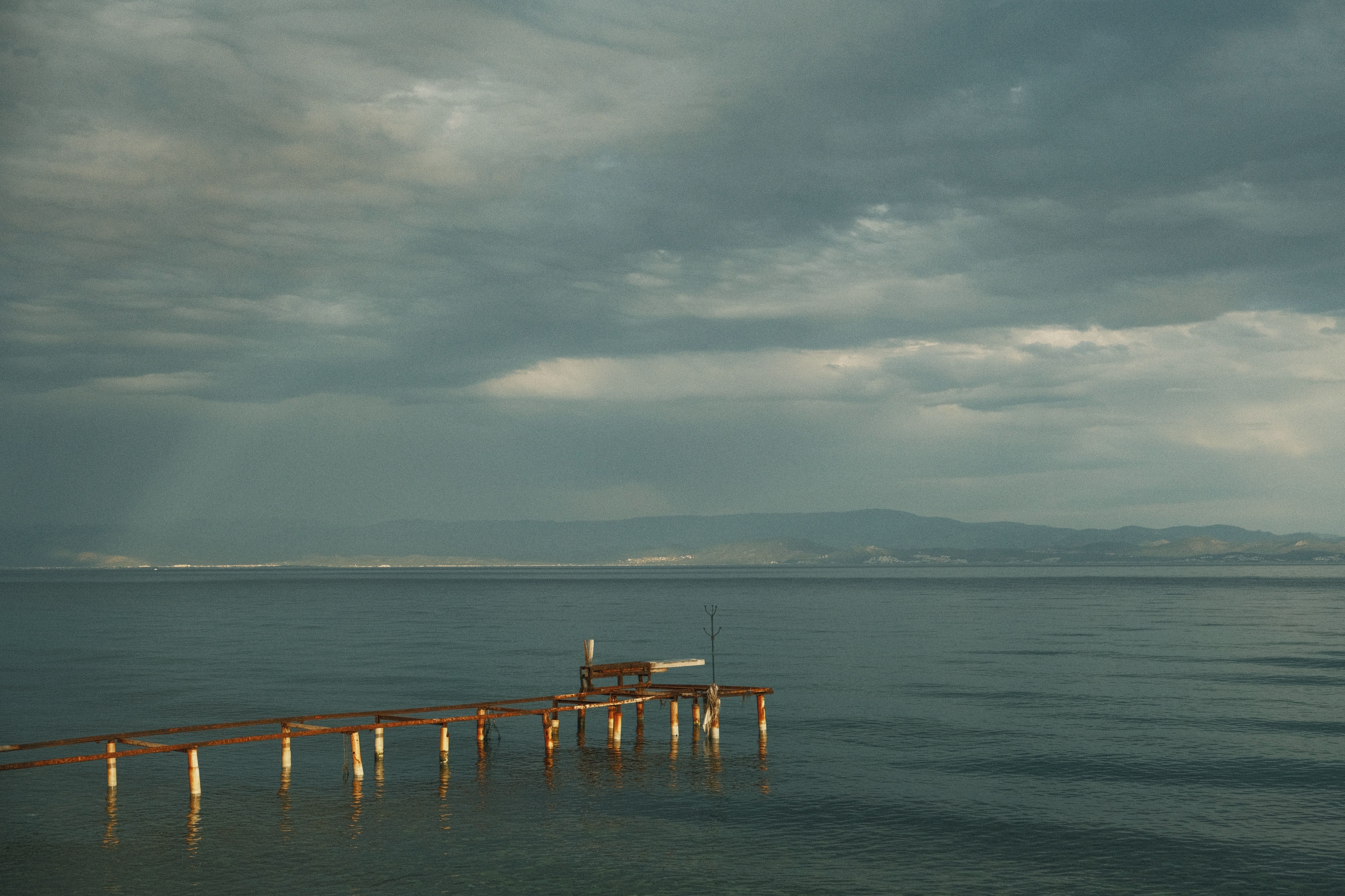 Brown Wooden Dock on Sea Under Gloomy Sky · Free Stock Photo