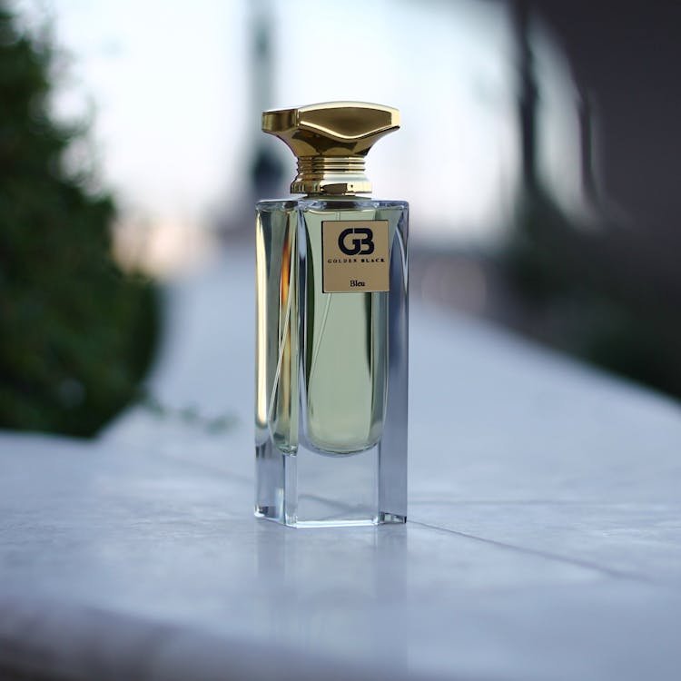 A Glass Perfume Bottle On A Flat Surface