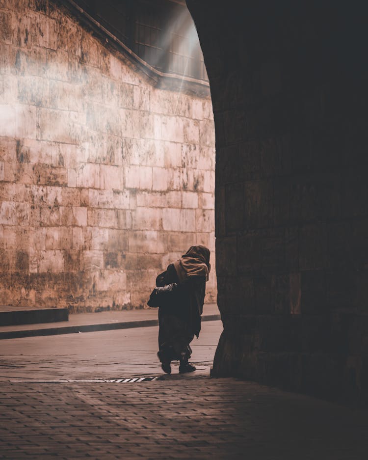 Photo Of An Elderly Person Walking On A Street