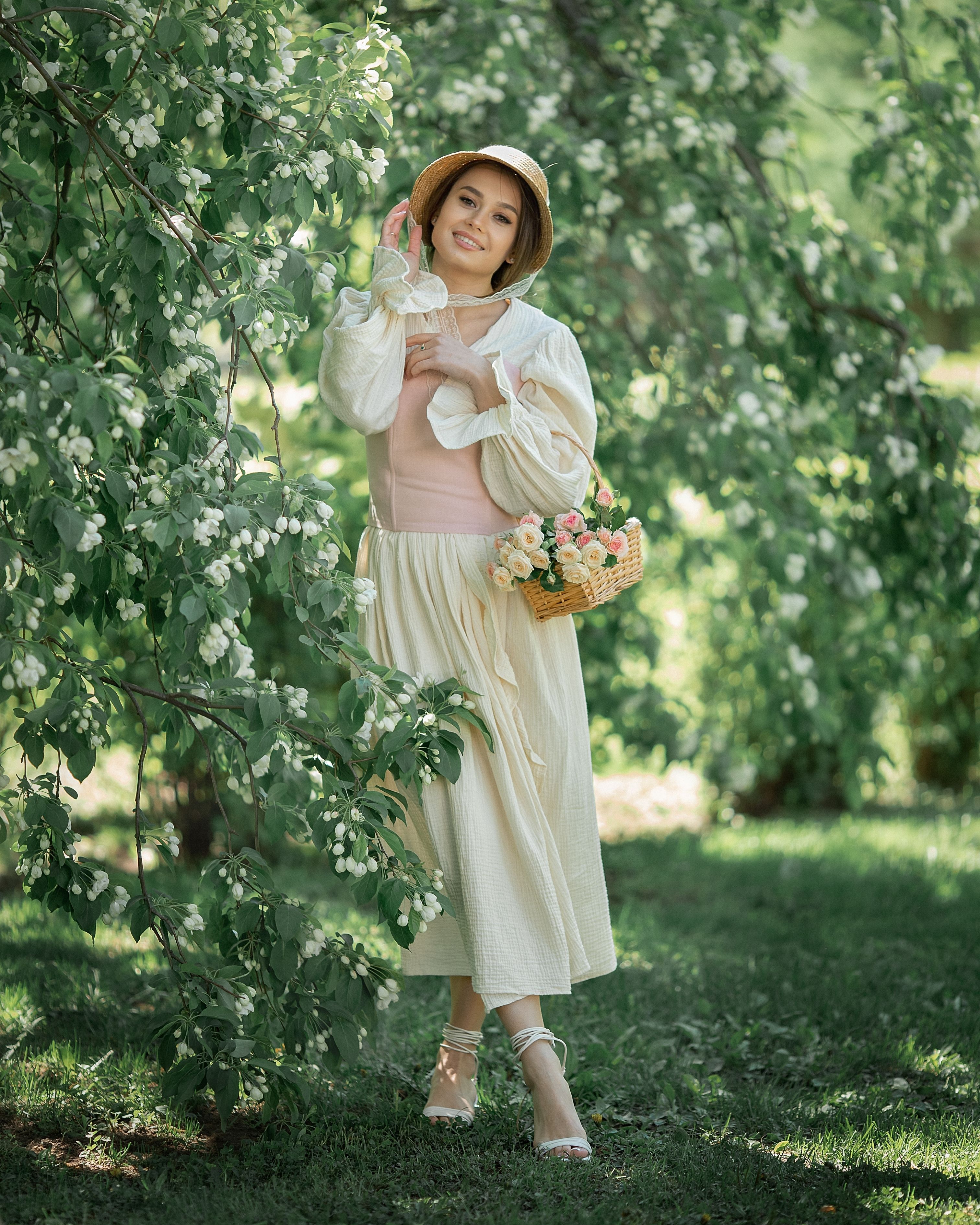 A Woman Carrying a Basket of Flowers · Free Stock Photo