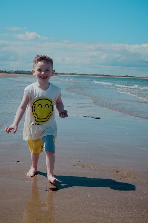 Photo of a Kid Smiling at the Beach
