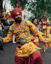 Man in Traditional Clothing Dancing on a Parade