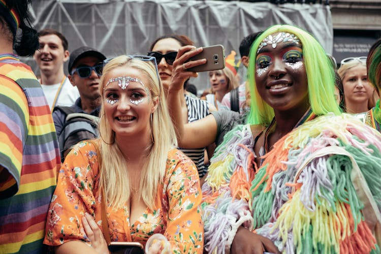 Women In Colorful Clothing And Makeup At A Parade 