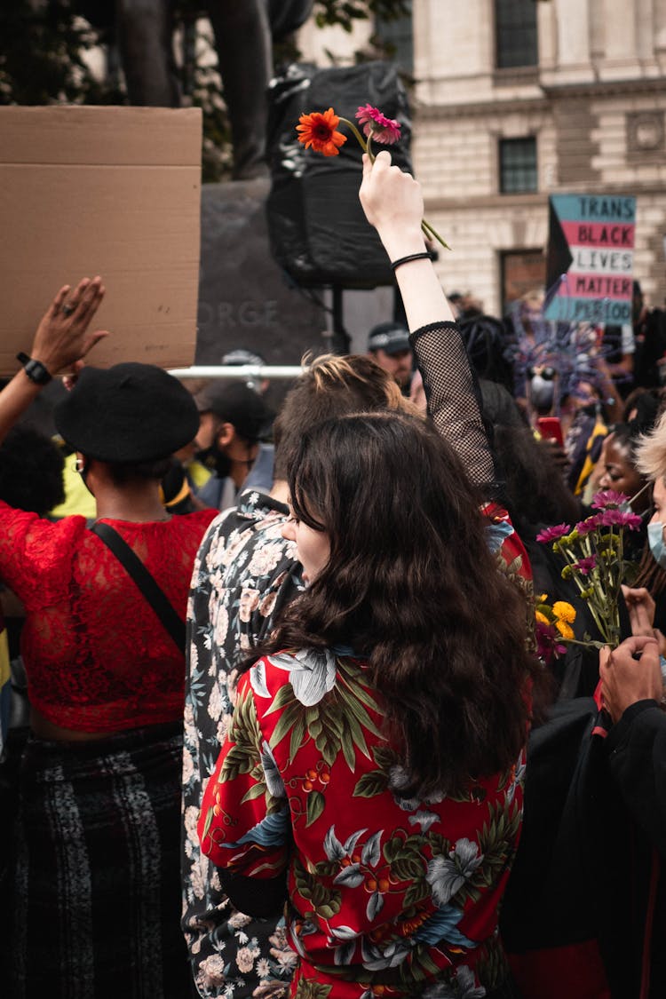 Woman Holding Flowers At Rally