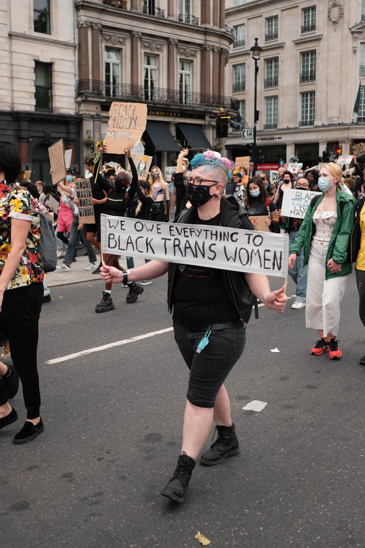 Person Wearing Face Mask Marching With Protest Sign