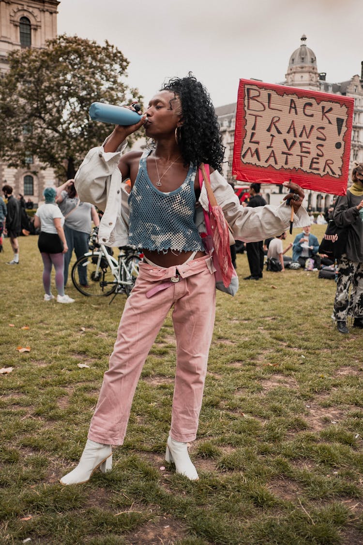 Woman With Cardboard Sign At Protest