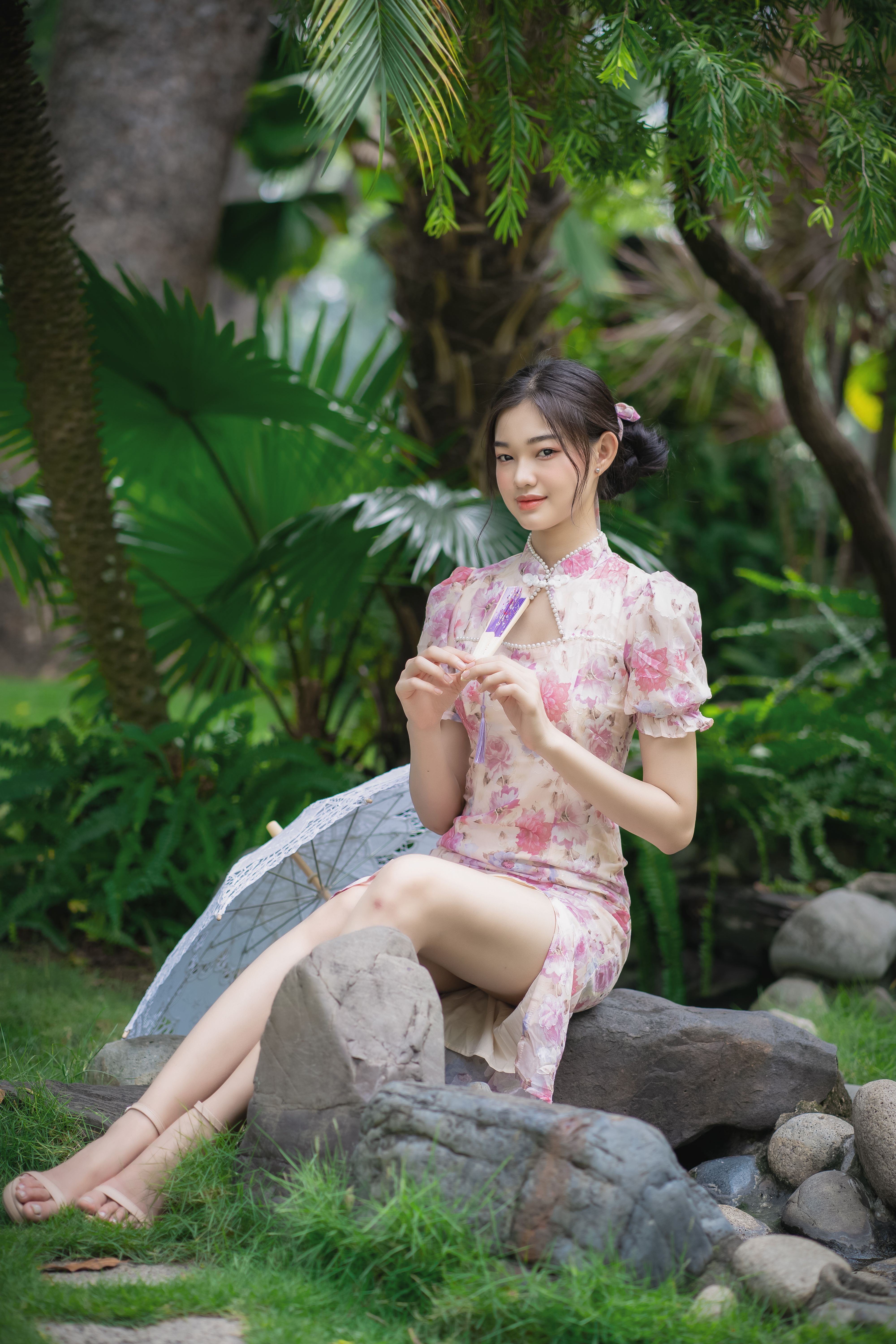 Woman in Pink and White Floral Dress Sitting on Gray Rock · Free Stock ...