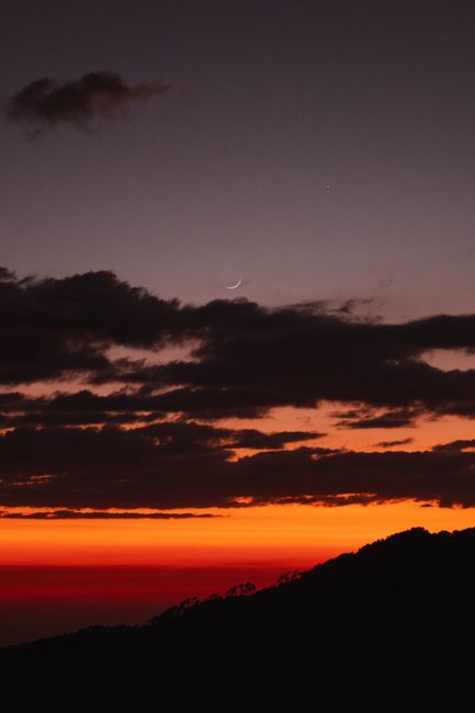 A breathtaking sunset over mountains in Santiago Nuyoó, Oaxaca, with vibrant orange and silhouette.