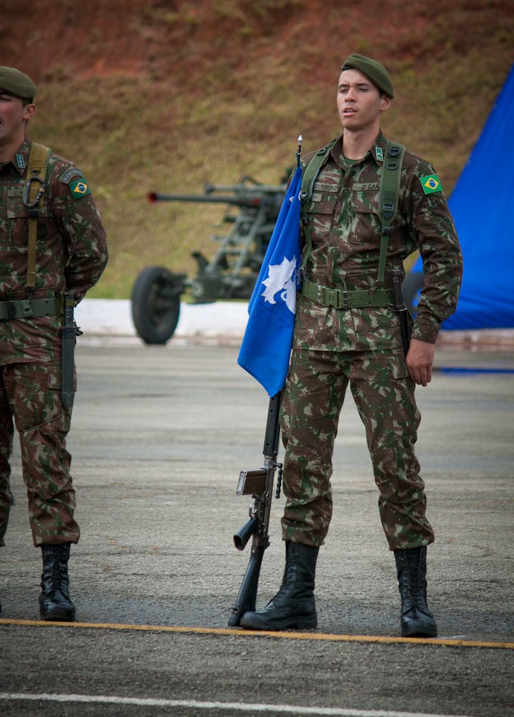 Man In Soldier Uniform Holding Blue Flag