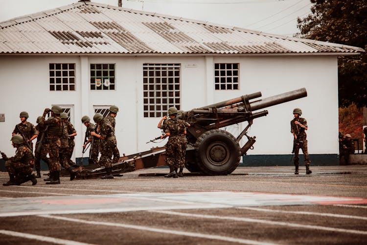 Soldiers In Military Uniform Near Heavy Artillery