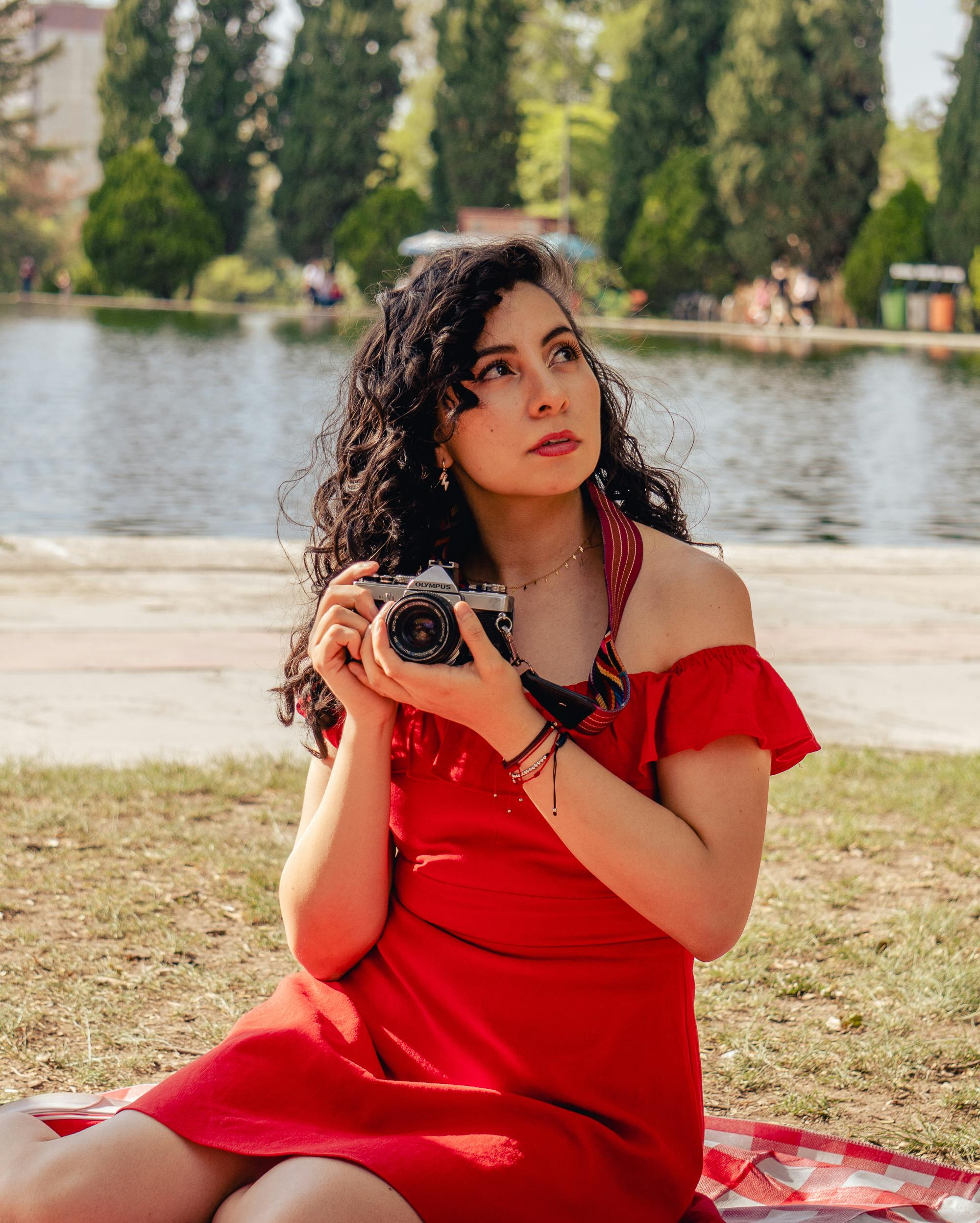 a woman in a red dress holding a camera