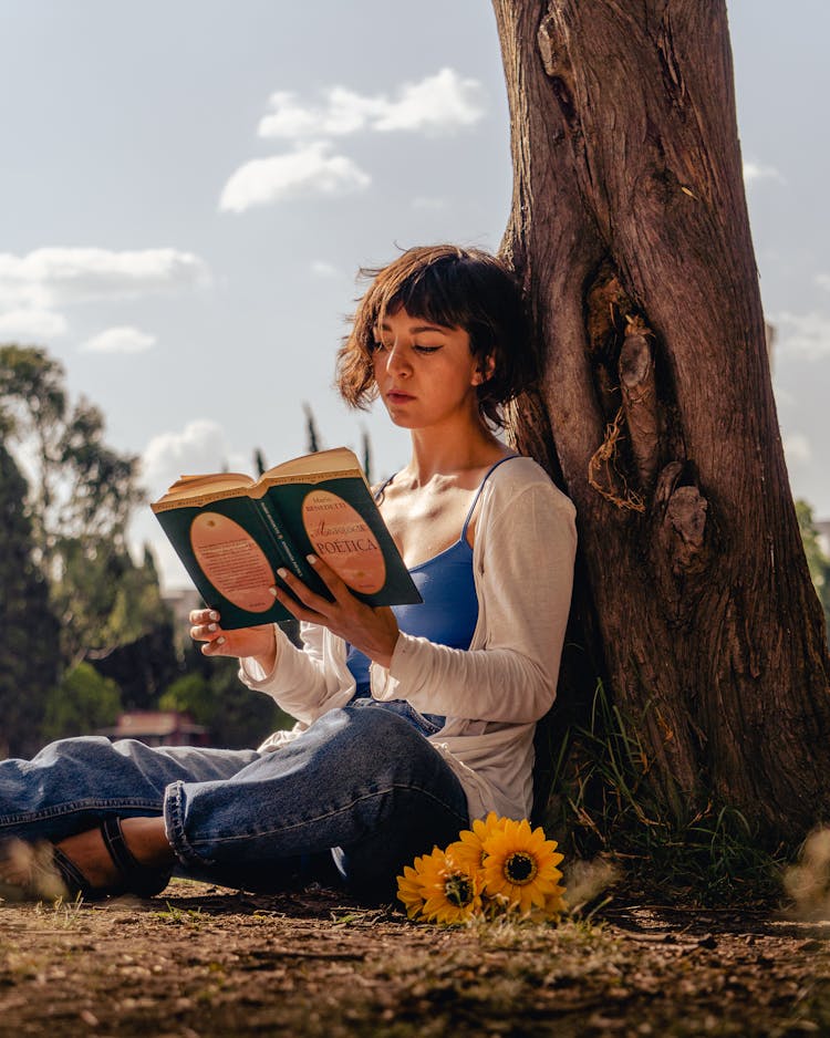 Woman Reading Book By Tree