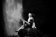 Woman on Rock near Waterfall