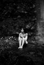 Woman Sitting near Flowers
