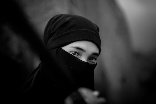 A Grayscale Photo of a Person Wearing Hijab