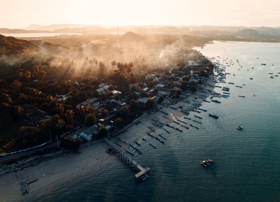 Beautiful aerial view of a coastal town in West Nusa Tenggara, Indonesia during sunrise.