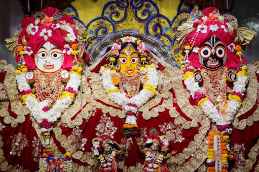 Beautifully adorned ISKCON deities with ornate decorations inside a temple.
