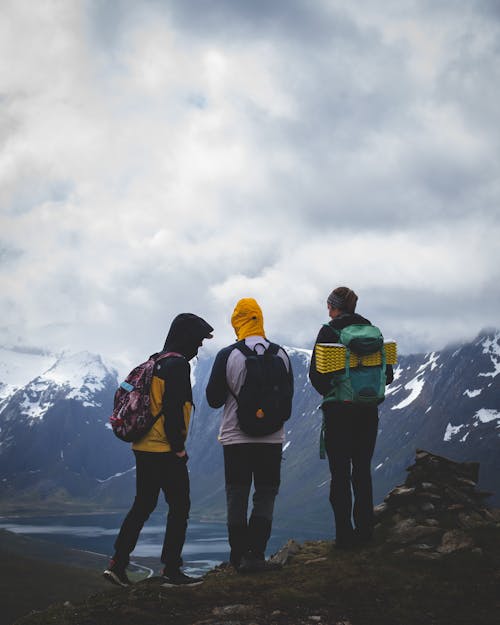 Free Backpackers Standing on a Cliff Stock Photo