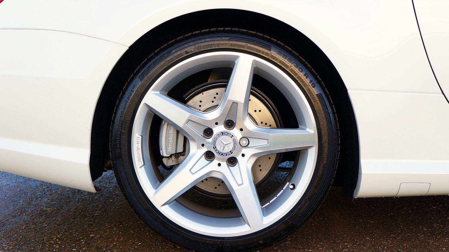 A White Mercedes Benz Car with Silver Mag Wheels