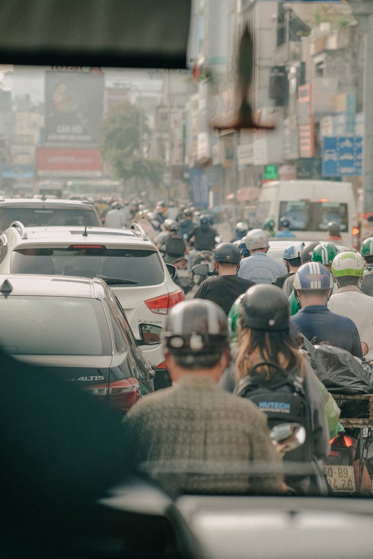 People On Scooters In Traffic Jam