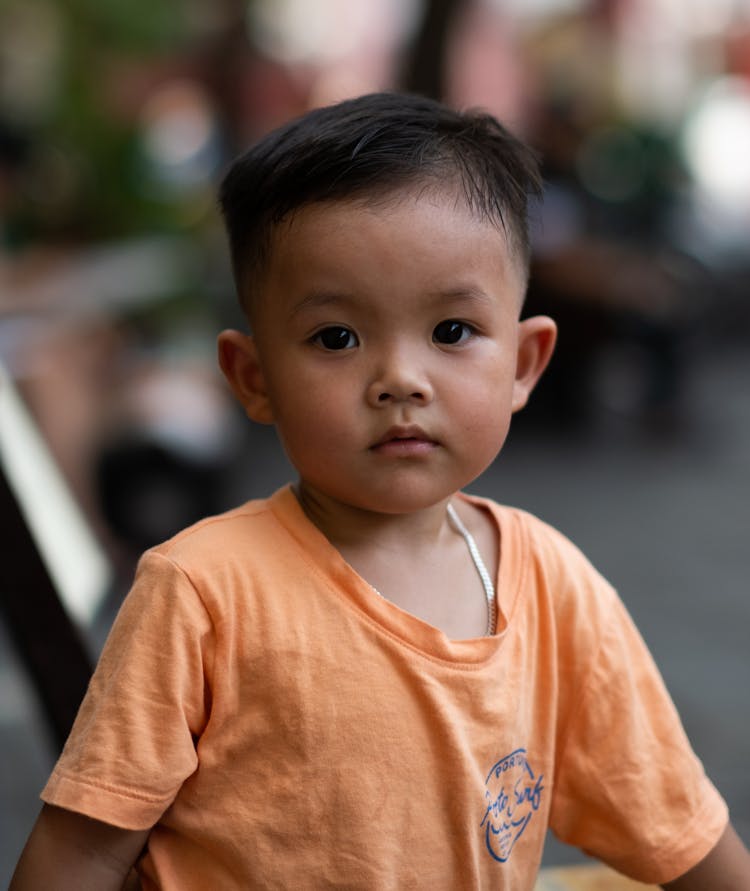 A Boy Wearing An Orange Shirt