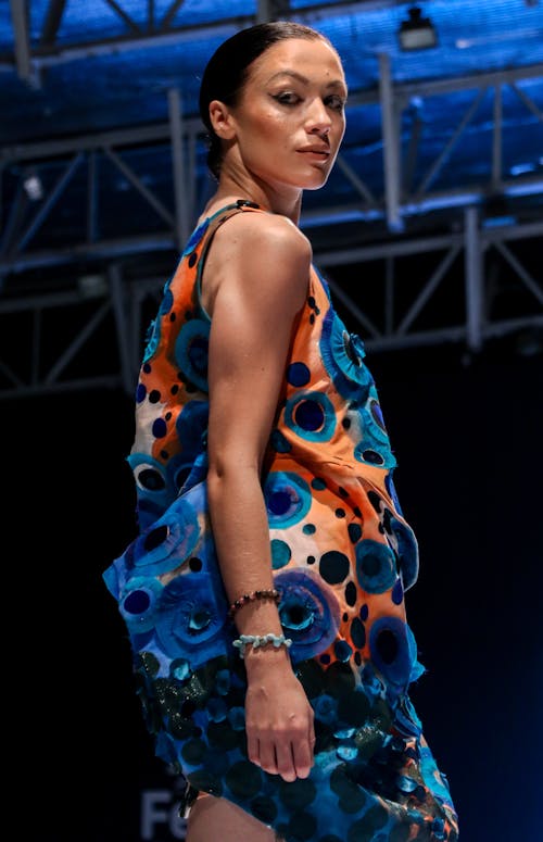 Woman in Orange, Blue, and Black Floral Sleeveless Dress