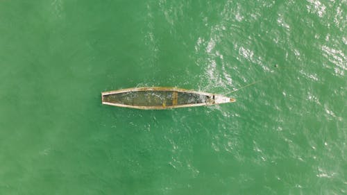 An Aerial Photography of a Wooden Boat on the Sea