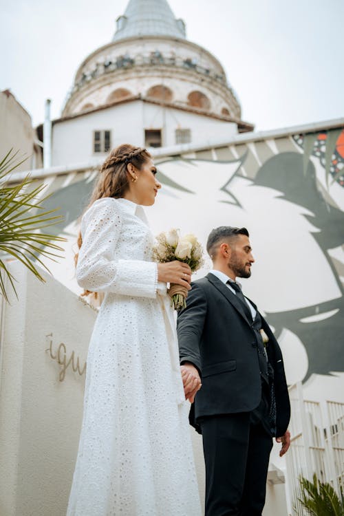 Newlywed Couple Standing in front of the Church 