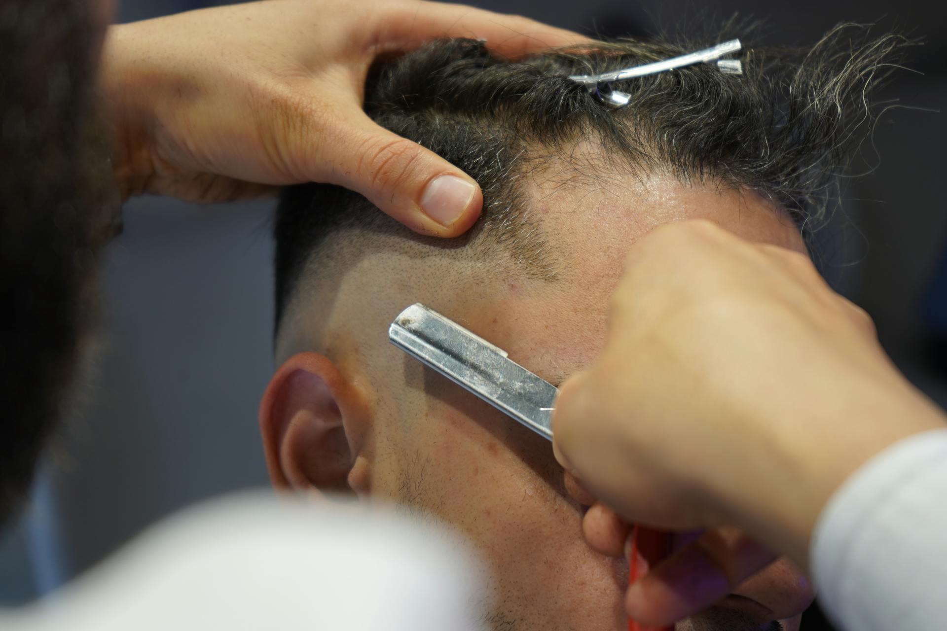 A Barber Using a Razor Blade