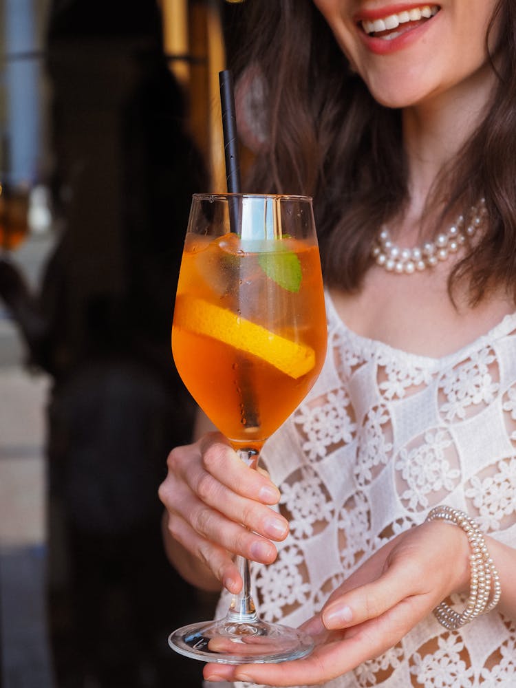 A Woman Holding A Cocktail Drink