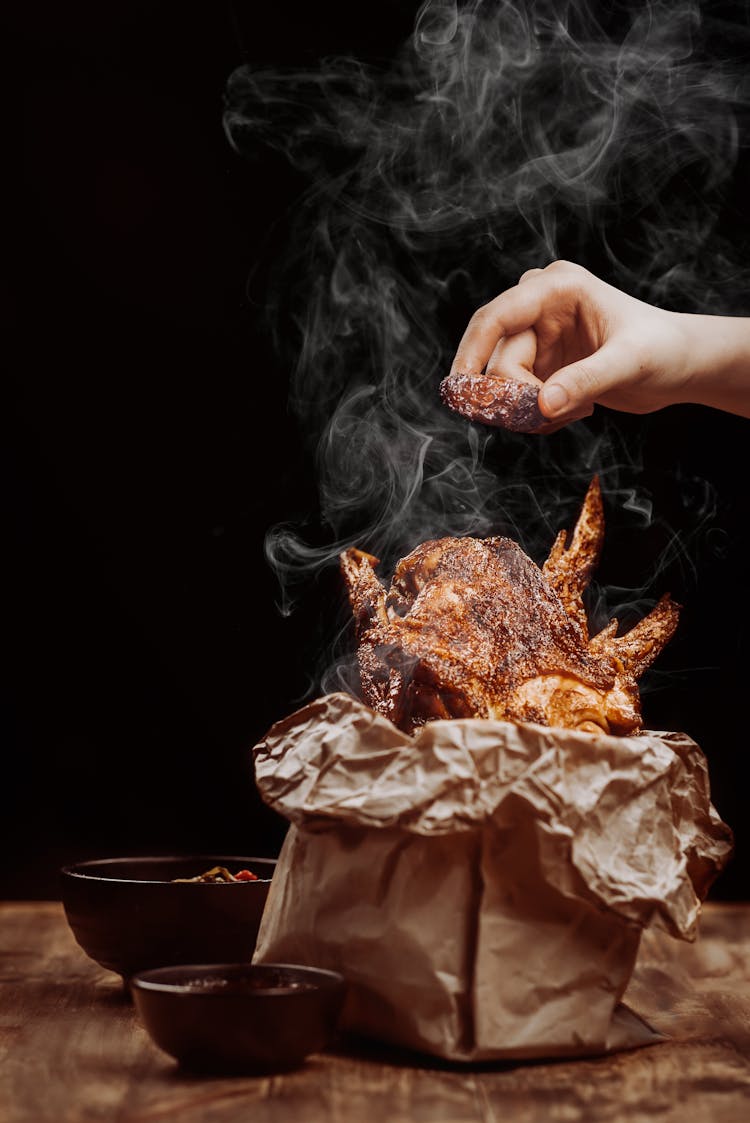 Woman Roasting A Chicken