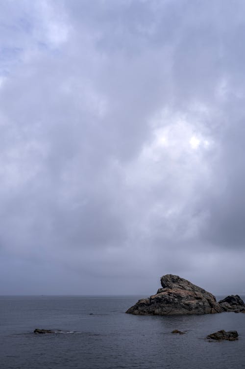 Gray and Black Rock Formation Under White Clouds