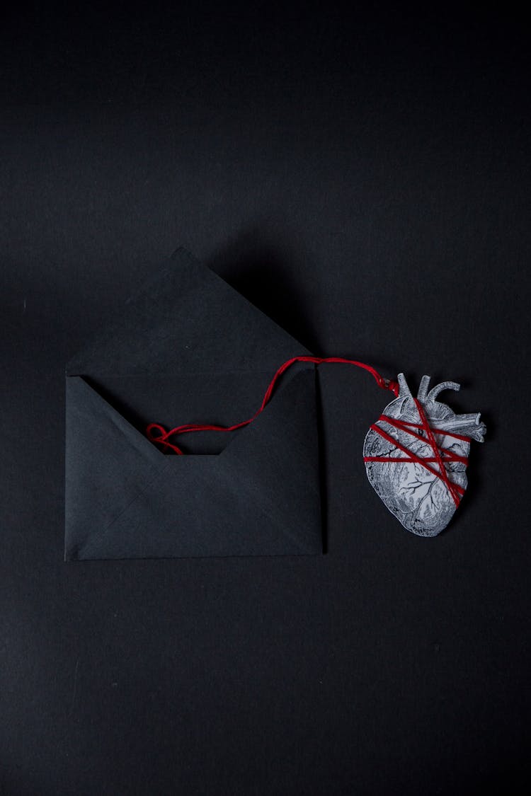 Real Heart Paper Cutout Attached To An Envelope With A String 