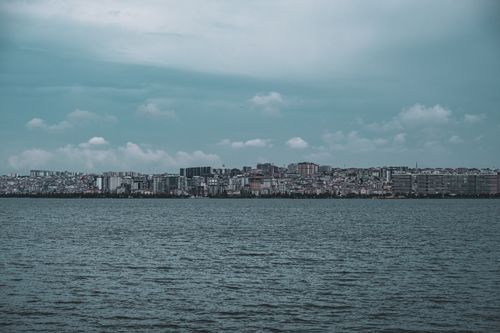 Free Panoramic view of Istanbul's urban skyline across the sea, under a cloudy sky. Stock Photo