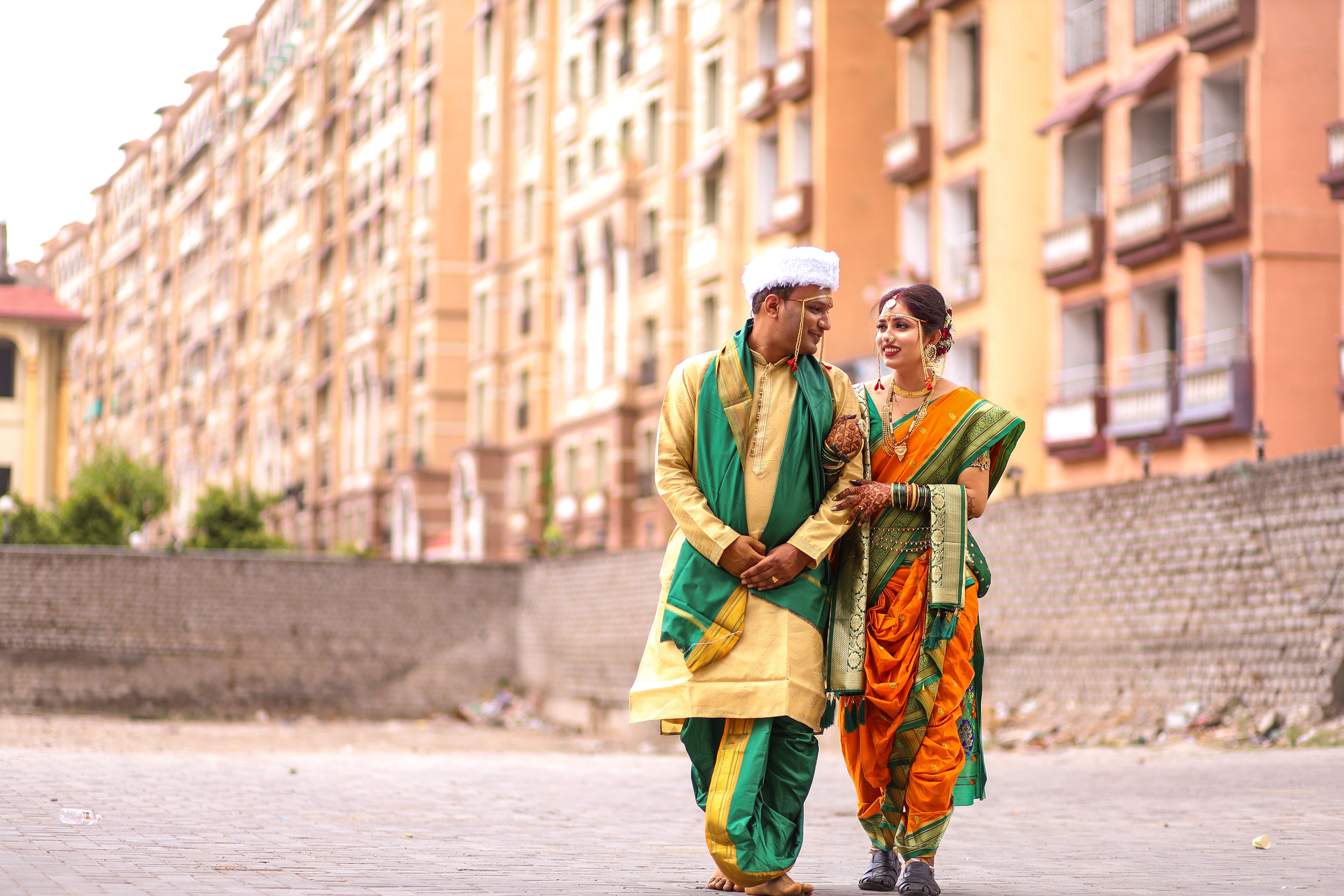 Indian couple in traditional attire walking outdoors in Nagpur, India.