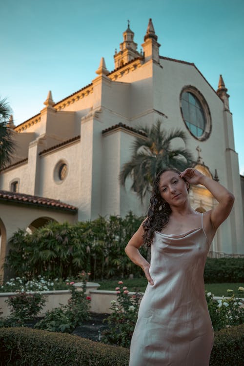 A Woman in Brown Spaghetti Strap Dress Near Brown Church