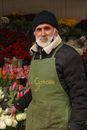 Elderly Man Selling Flowers on a Market 
