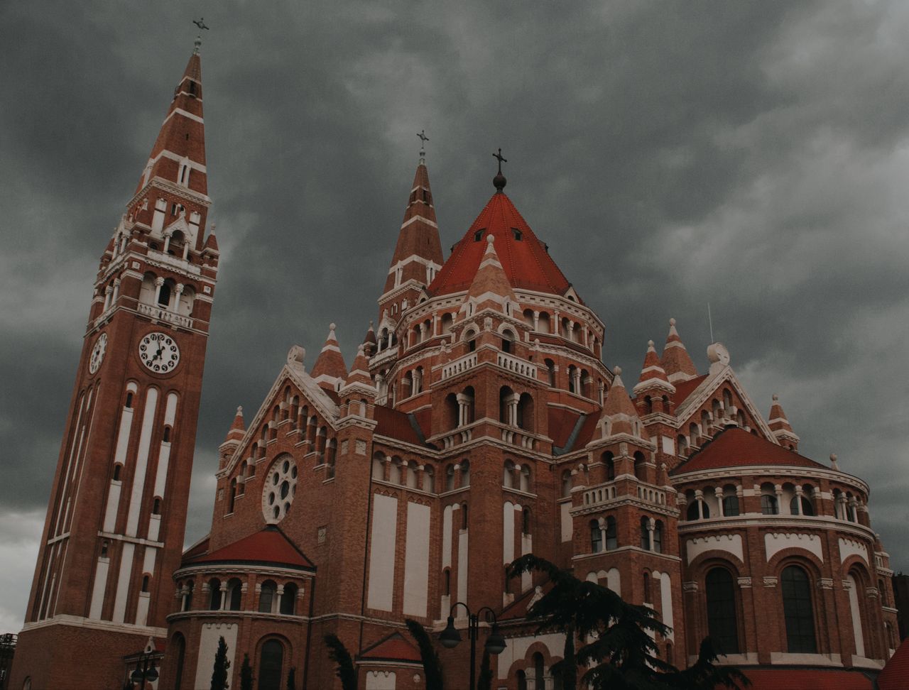 the iconic votive church in szeged hungary under dramatic stormy skies