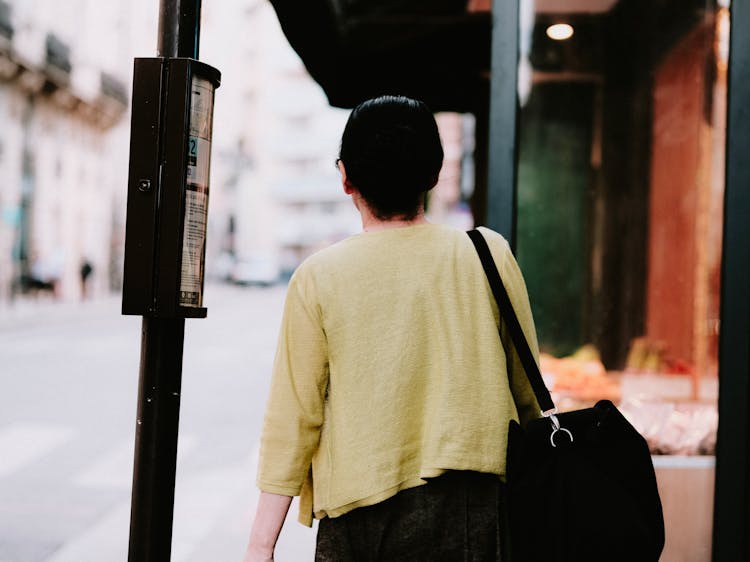 Person Walking With A Bag 