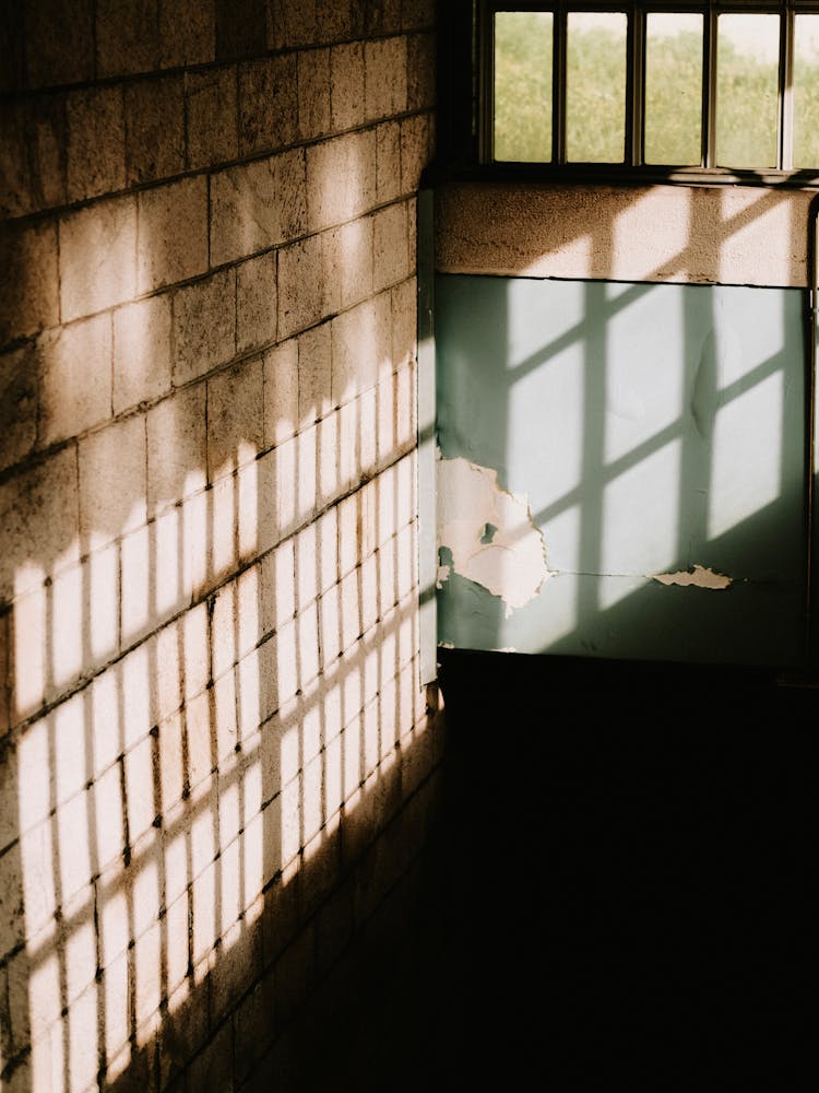 A Light Casting Square And Rectangle Shadows On Brown Wall