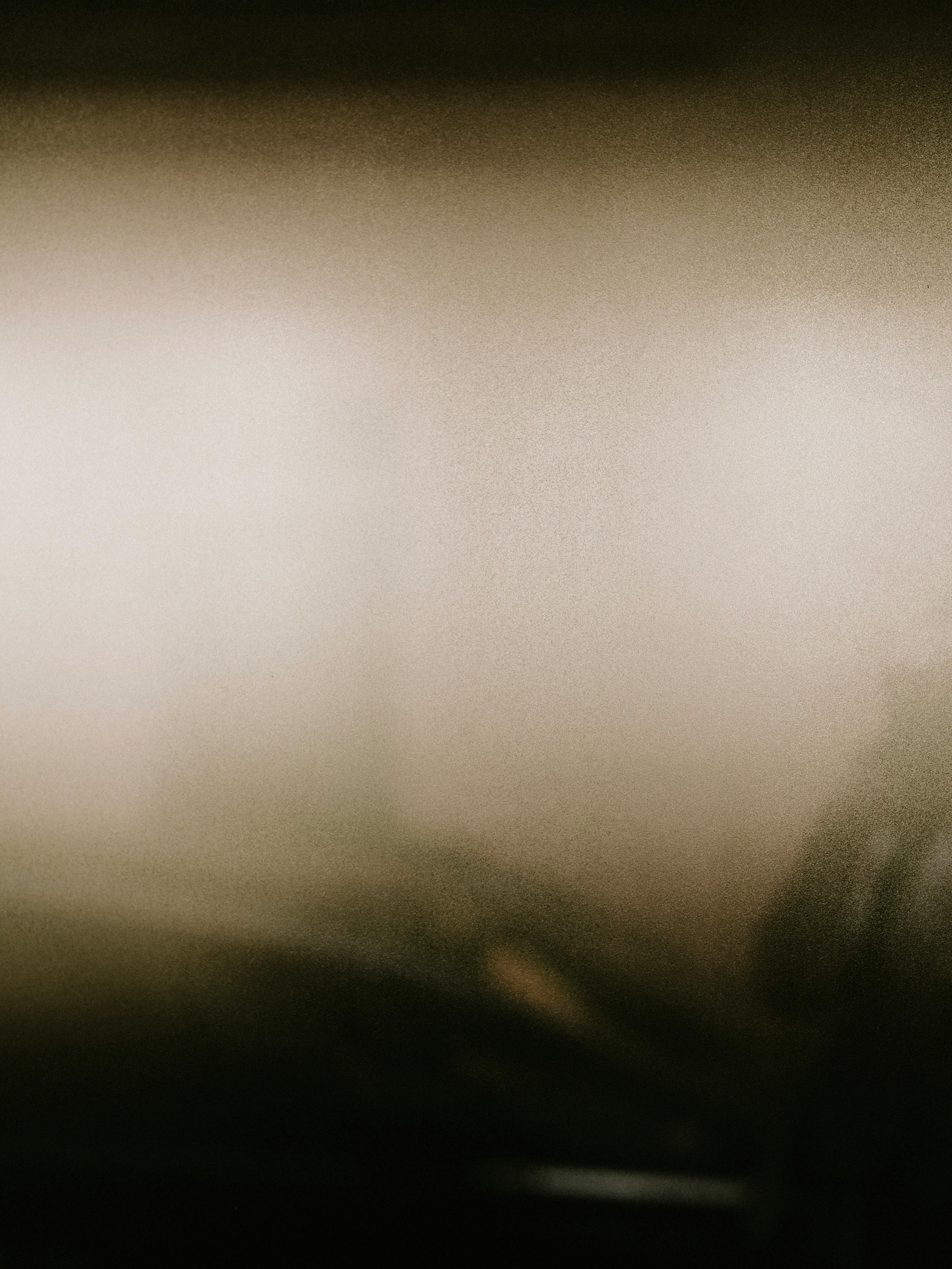 A blurred and grainy abstract image with shining light effects, creating a mysterious atmosphere.