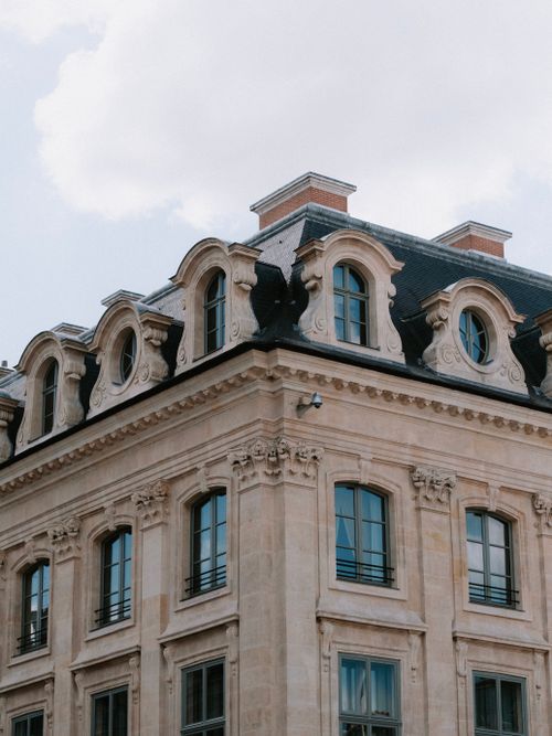 Free A detailed view of a classic European building with Baroque architectural features under a clear sky. Stock Photo