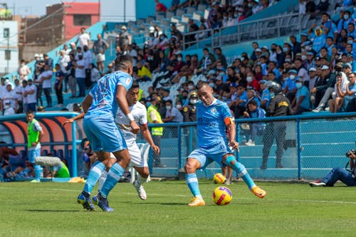 Sportsmen Playing Football on the Football Pitch 