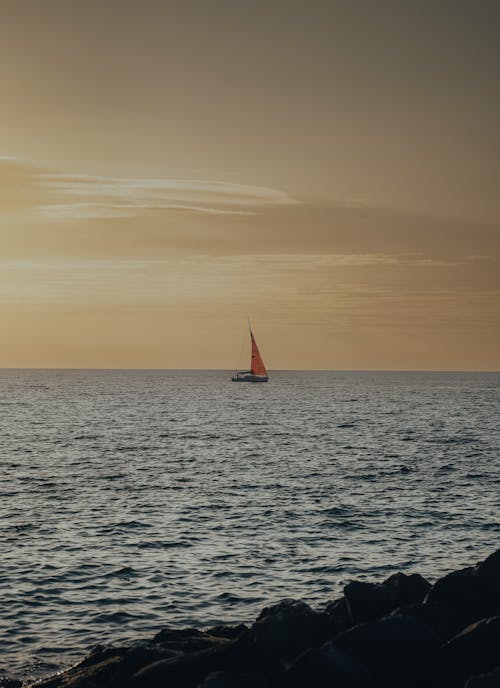 Sailboat on Sea during Sunset