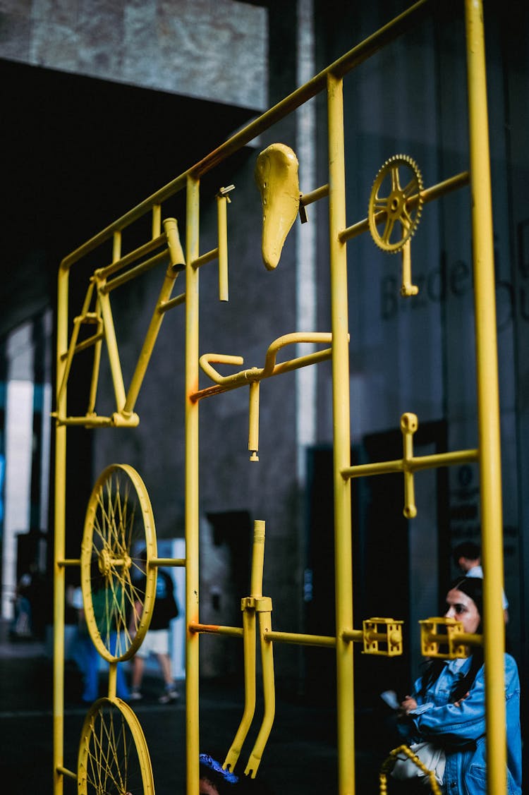 Unassembled Yellow Bicycle Parts On Yellow Steel Frame