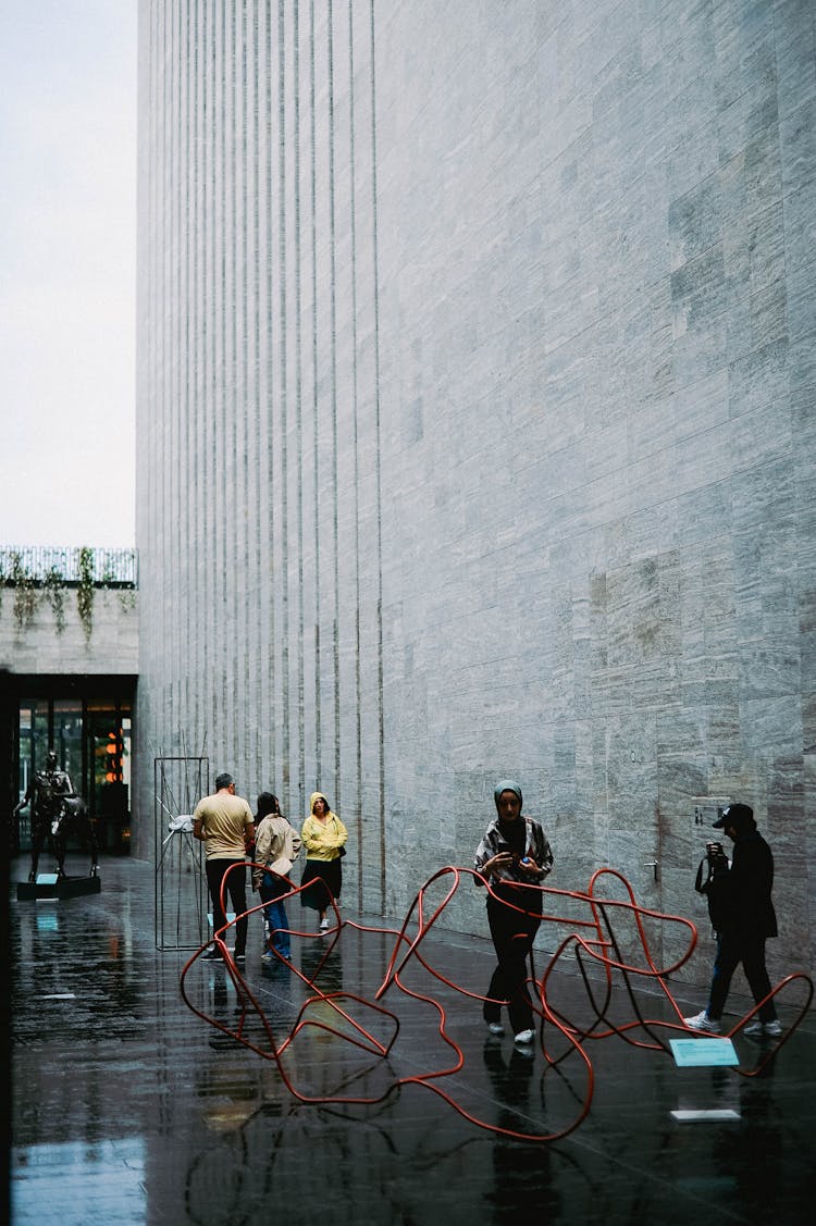 People Walking Outside A Modern Art Museum 