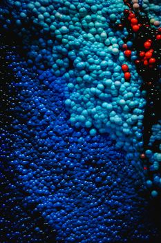 Close-up of colorful abstract bubbles in blue and red hues, creating a textured pattern.