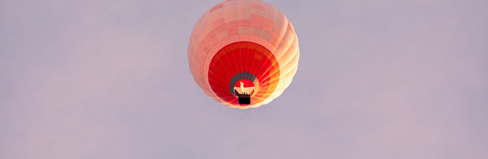 Vibrant hot air balloon floating gracefully in the serene sky, a perfect adventure moment.