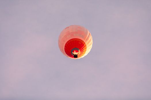 Vibrant hot air balloon floating gracefully in the serene sky, a perfect adventure moment.
